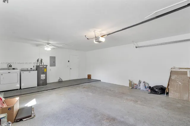 a view of a storage & utility room with two washing machine