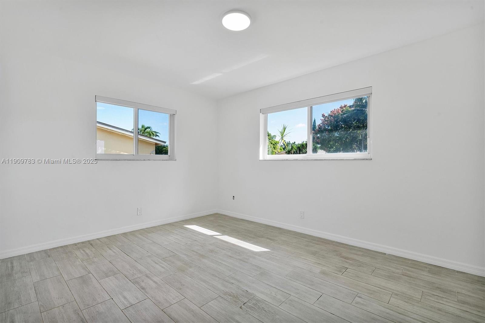 4309 Jackson Street Hollywood, FL 33021 - Photo 19 of 39 an empty room with wooden floor and window