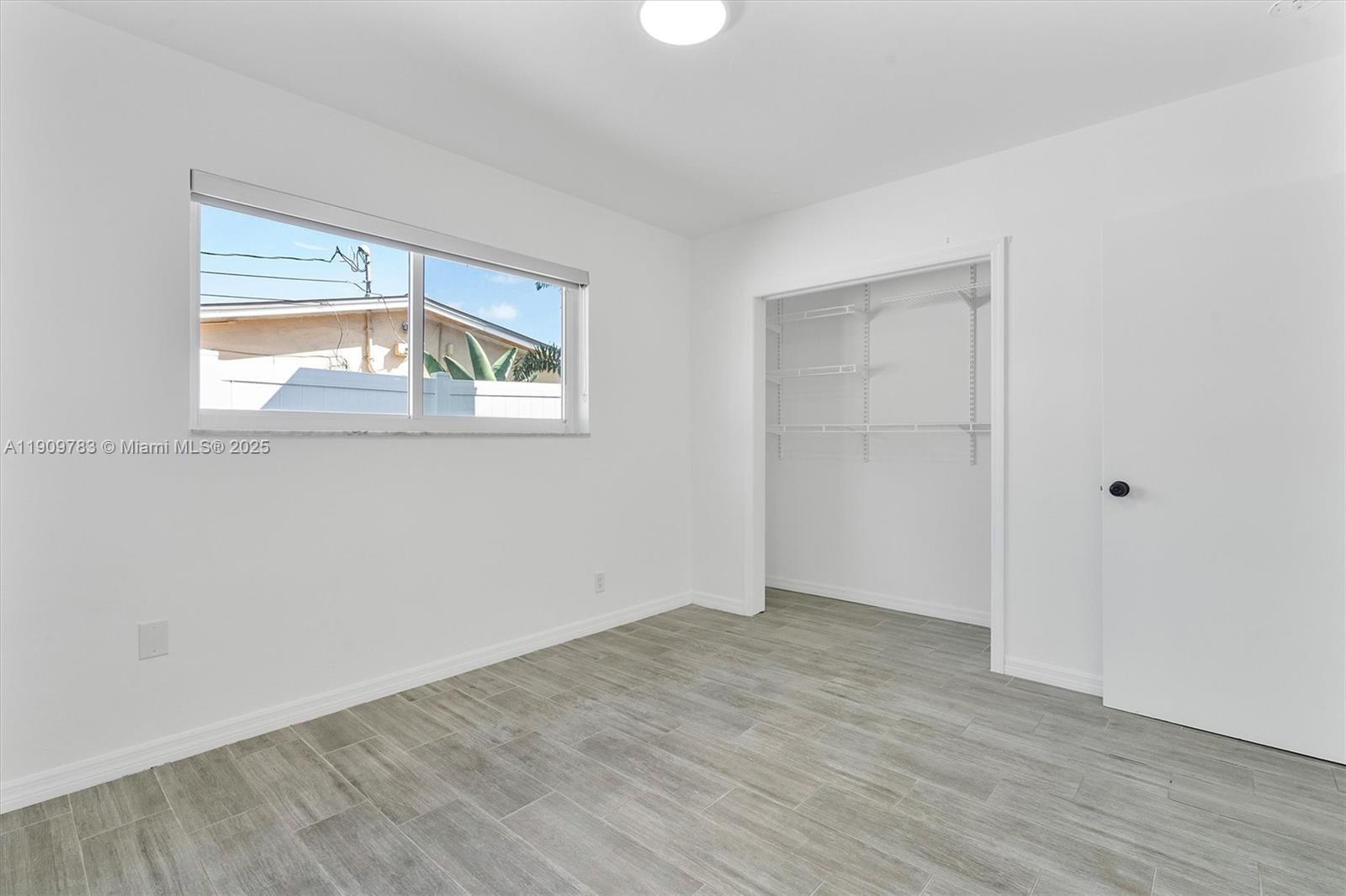 4309 Jackson Street Hollywood, FL 33021 - Photo 22 of 39 an empty room with wooden floor and windows
