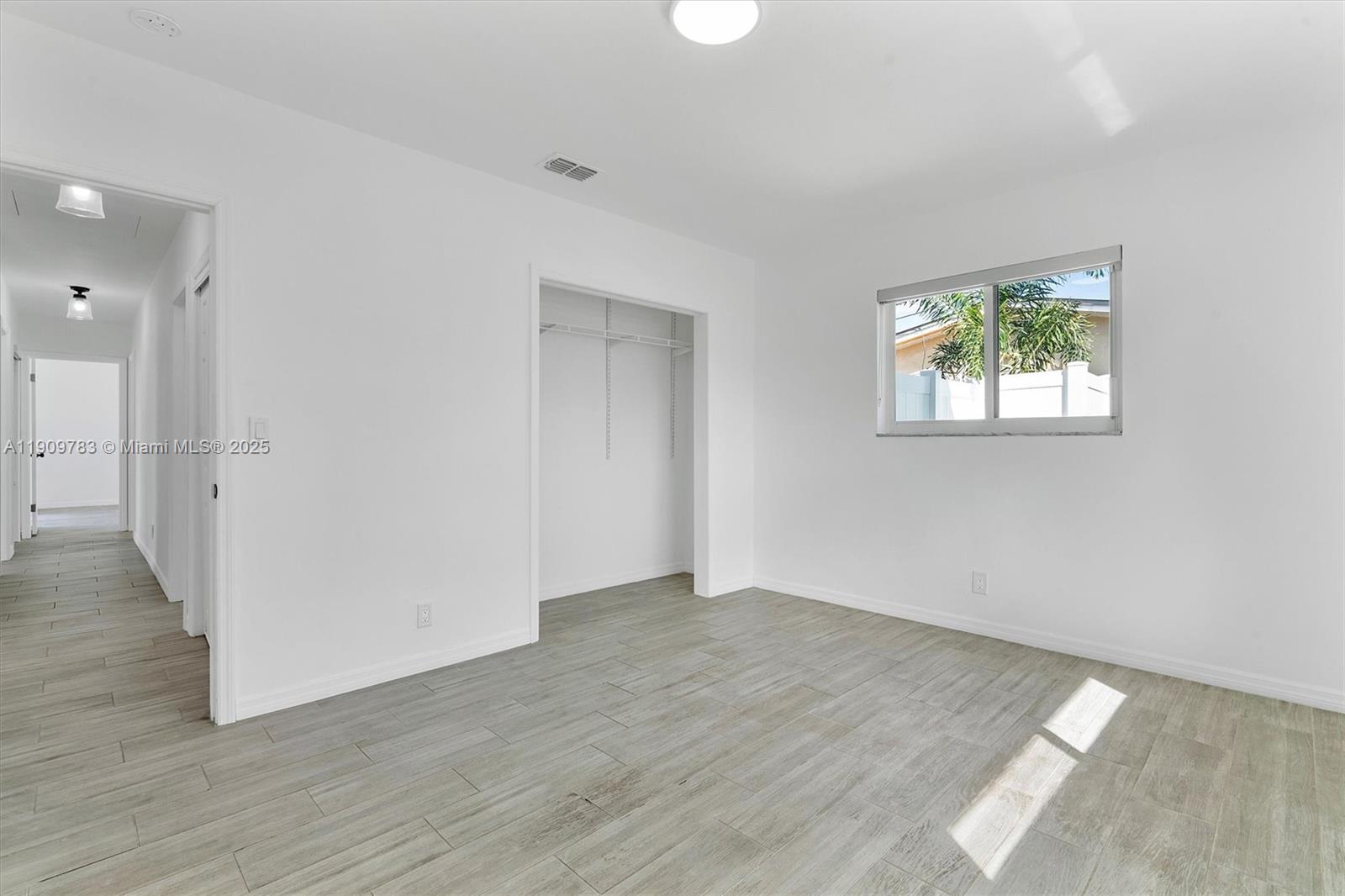 4309 Jackson Street Hollywood, FL 33021 - Photo 23 of 39 an empty room with wooden floor and windows