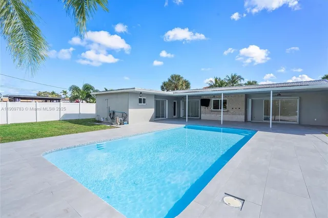 a view of a house with a swimming pool and a yard