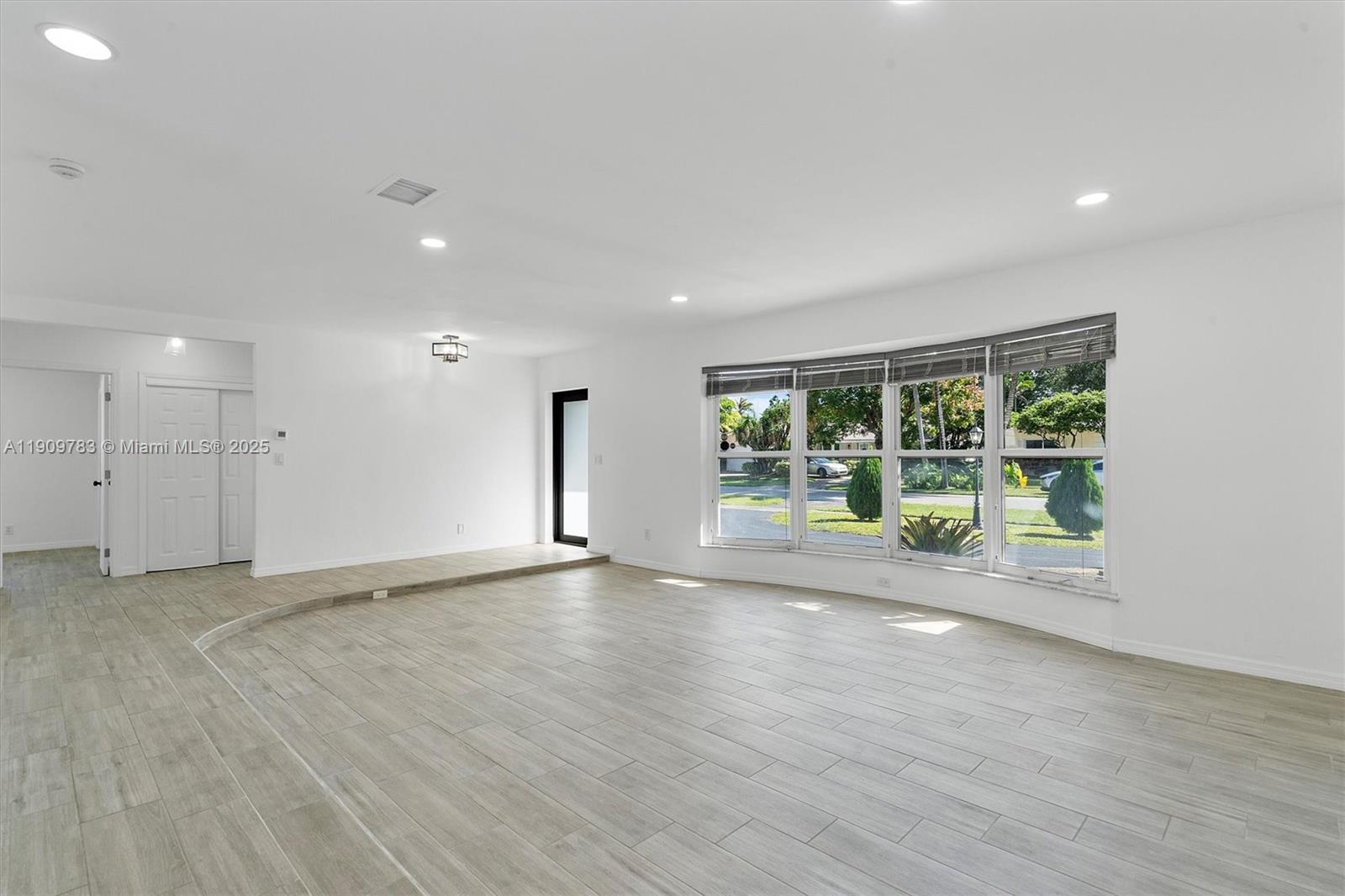 4309 Jackson Street Hollywood, FL 33021 - Photo 6 of 39 a view of an empty room with wooden floor and a window