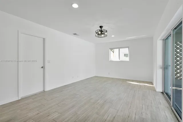 an empty room with windows and closet