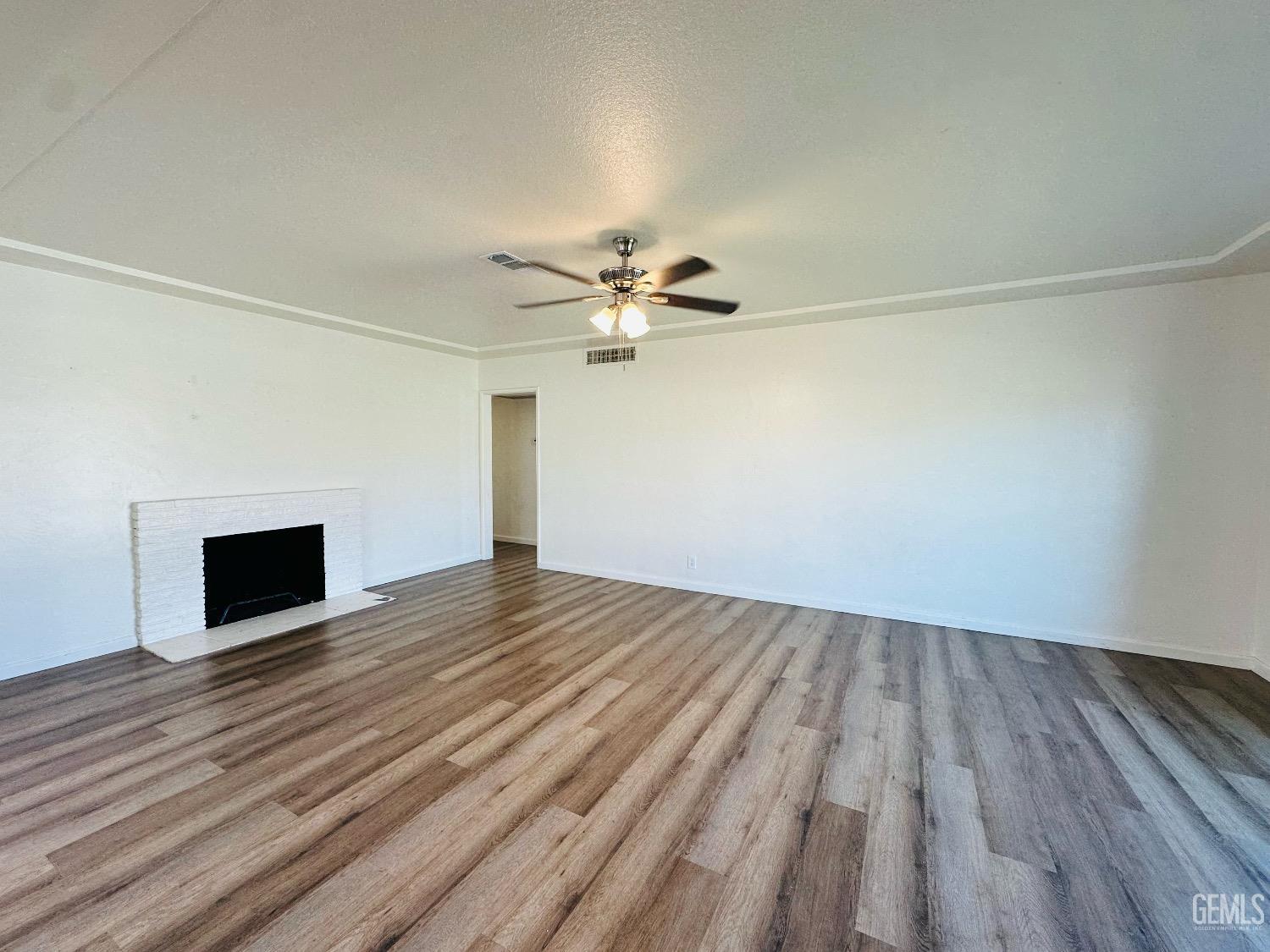 Undisclosed Address Bakersfield, CA 93304 - Photo 11 of 26 a view of empty room with wooden floor and fan