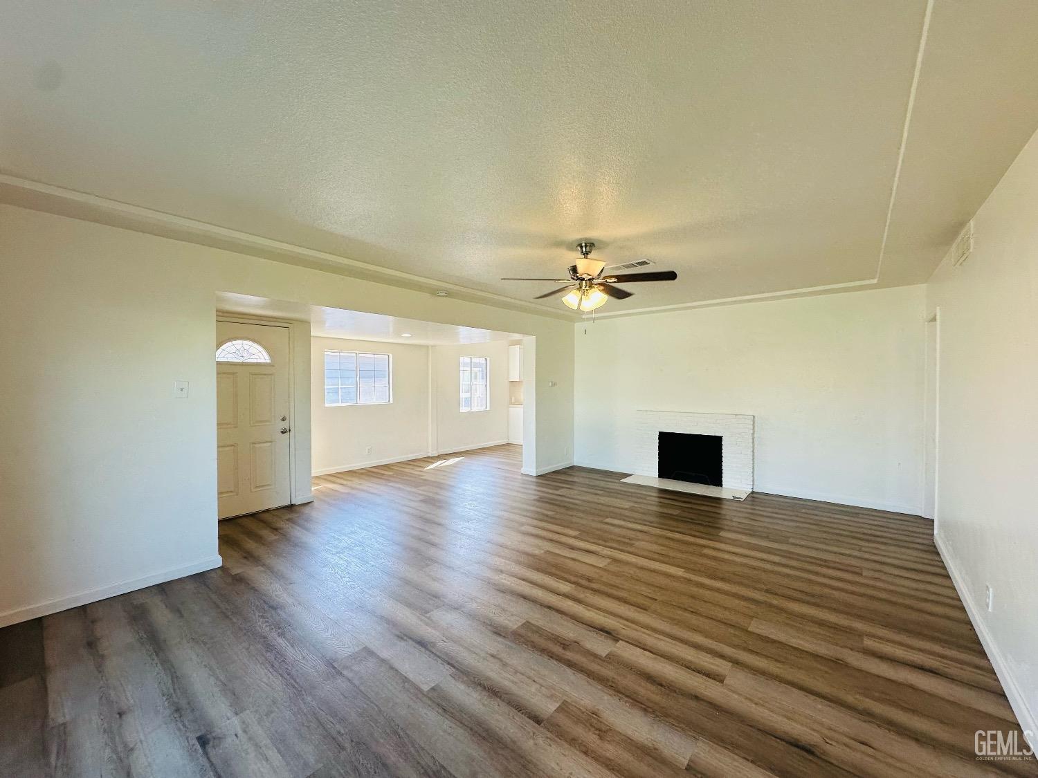 Undisclosed Address Bakersfield, CA 93304 - Photo 12 of 26 a view of empty room with wooden floor and window