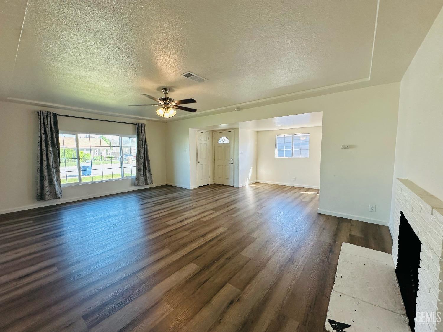 Undisclosed Address Bakersfield, CA 93304 - Photo 13 of 26 an empty room with wooden floor and windows