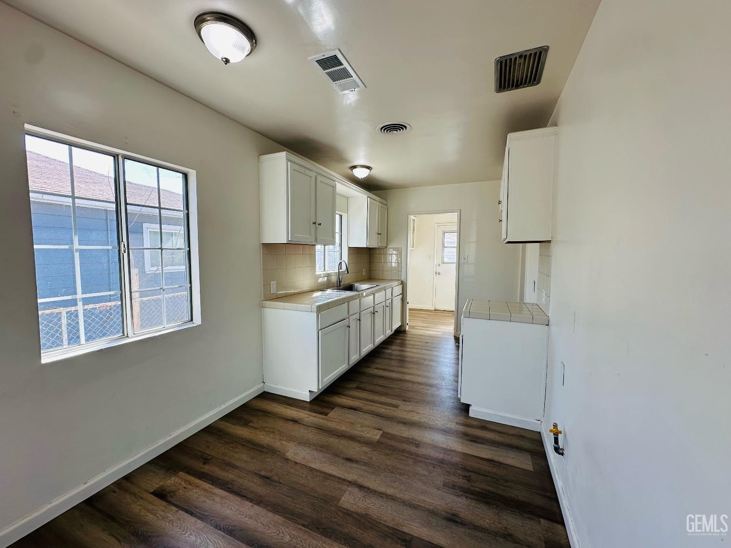 Undisclosed Address Bakersfield, CA 93304 - Photo 14 of 26 a kitchen with a refrigerator and window