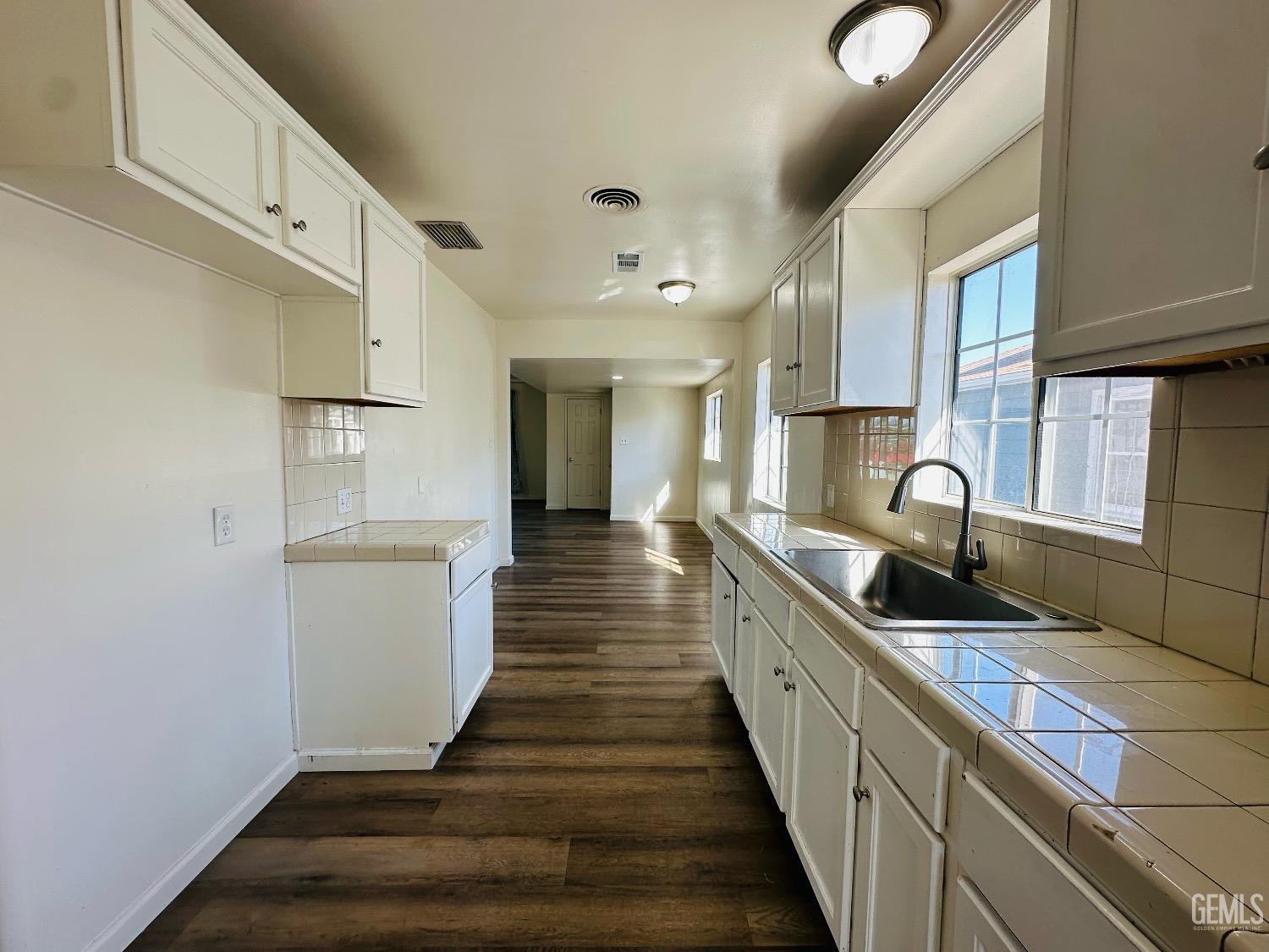 Undisclosed Address Bakersfield, CA 93304 - Photo 15 of 26 a view of a kitchen with kitchen island a sink stainless steel appliances and cabinets
