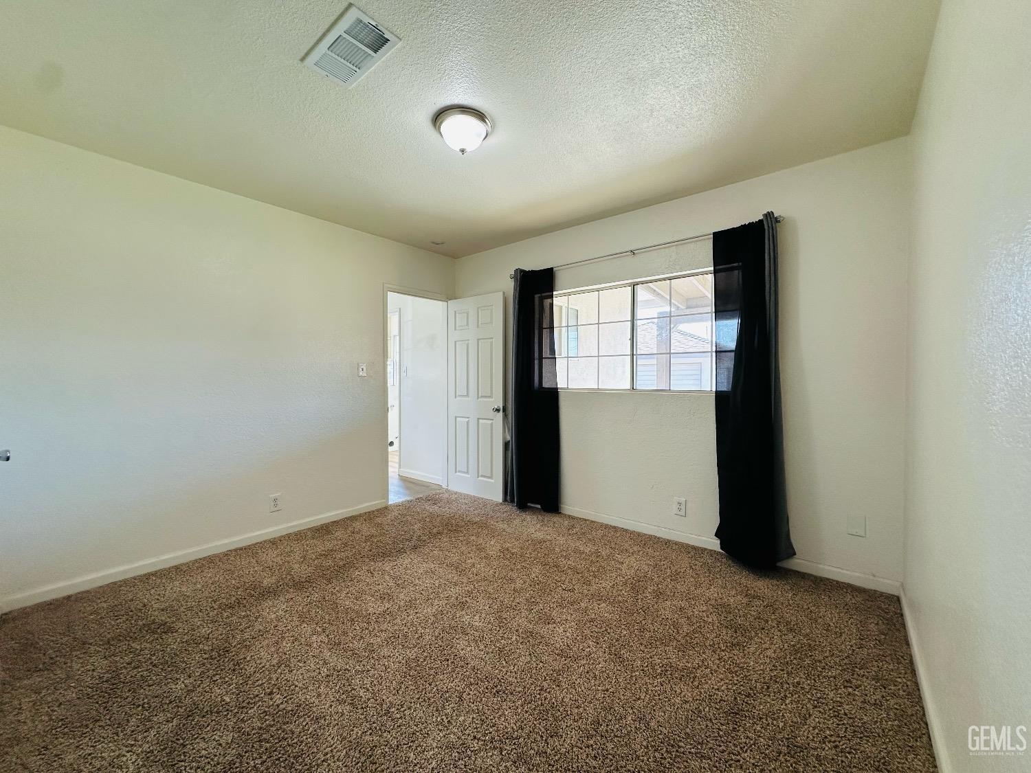 Undisclosed Address Bakersfield, CA 93304 - Photo 19 of 26 an empty room with windows