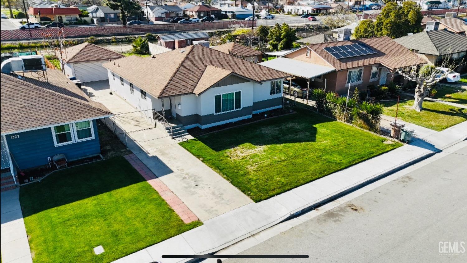 Undisclosed Address Bakersfield, CA 93304 - Photo 2 of 26 an aerial view of residential houses with yard
