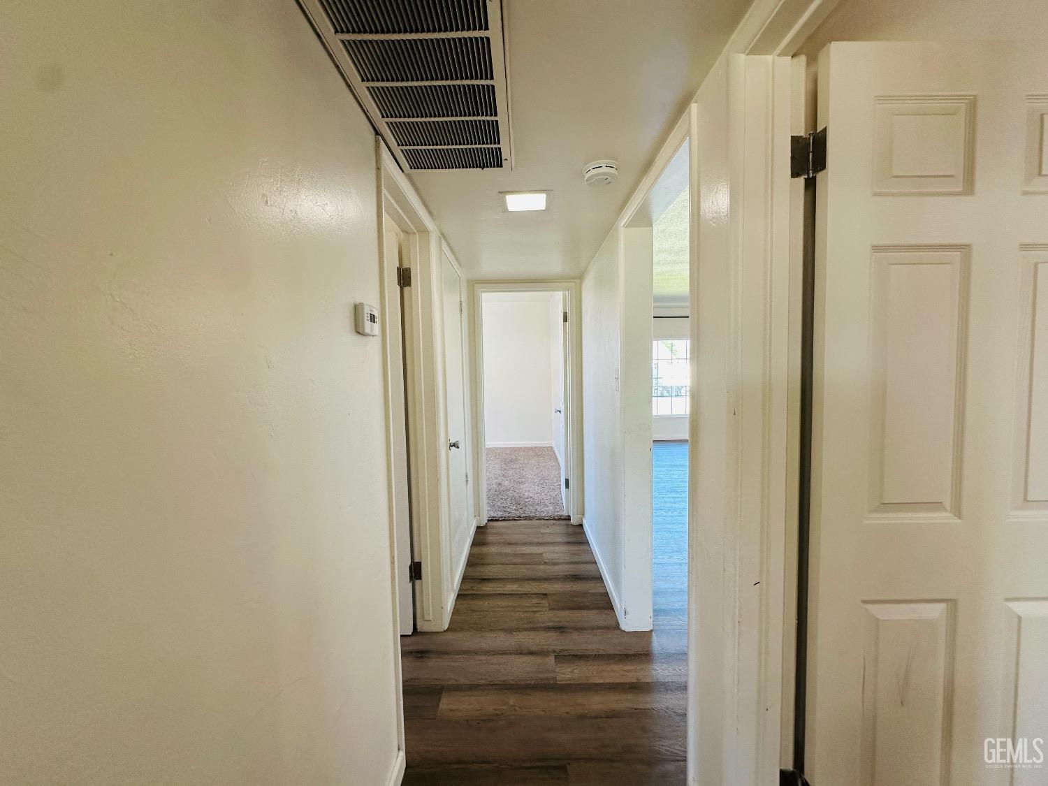 Undisclosed Address Bakersfield, CA 93304 - Photo 22 of 26 a view of a hallway with wooden floor and staircase