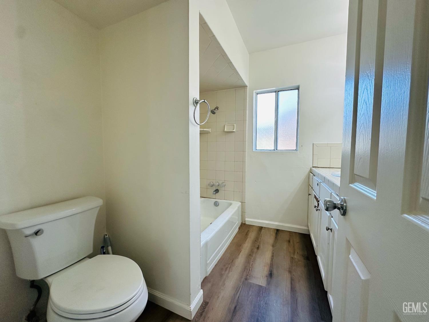 Undisclosed Address Bakersfield, CA 93304 - Photo 24 of 26 a bathroom with a granite countertop toilet a sink and a bathtub
