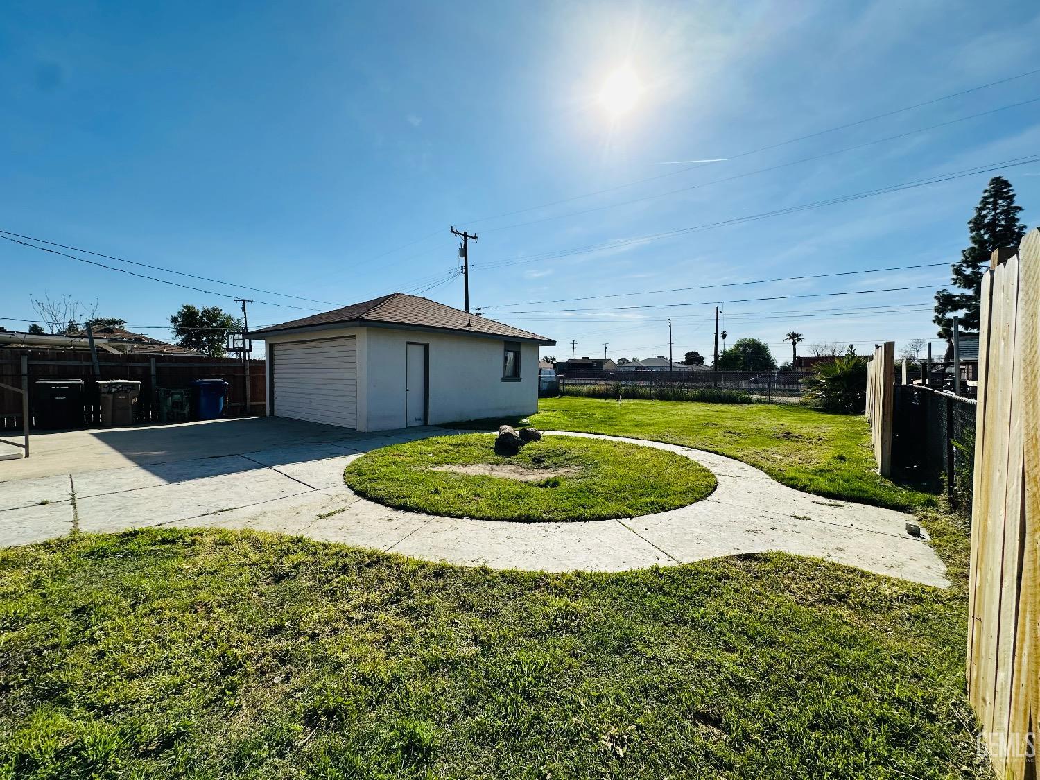 Undisclosed Address Bakersfield, CA 93304 - Photo 4 of 26 a view of a swimming pool with a yard