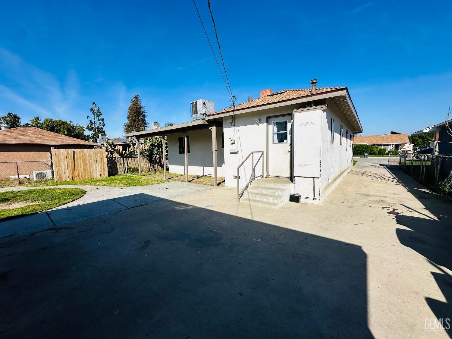 Undisclosed Address Bakersfield, CA 93304 - Photo 6 of 26 a view of a white house with a big yard