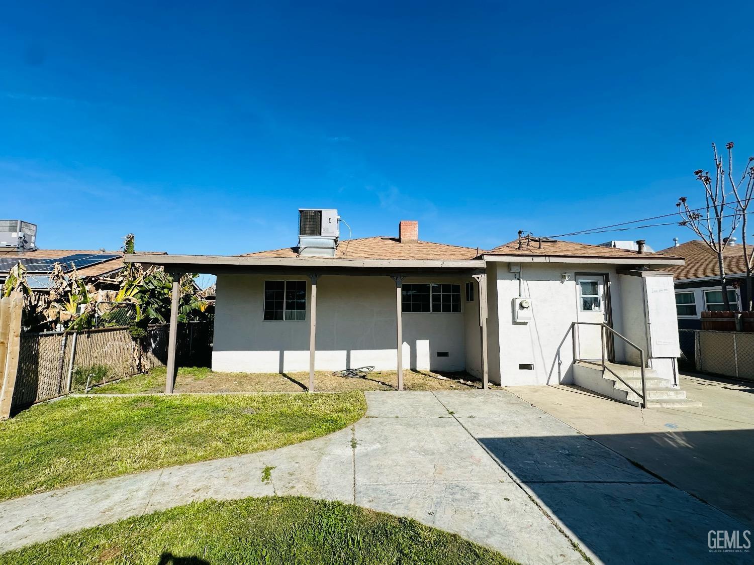 Undisclosed Address Bakersfield, CA 93304 - Photo 7 of 26 a front view of a house with a yard