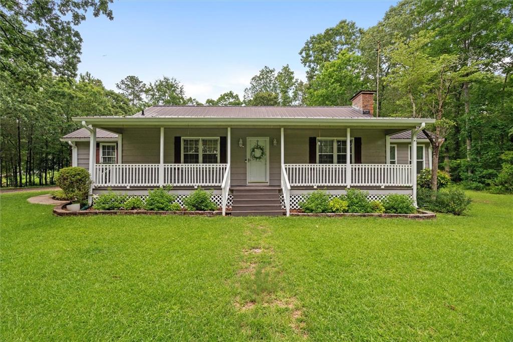 1267 Austin Bridge Road Douglasville, GA 30134 - Photo 1 of 66 a view of a house with a backyard
