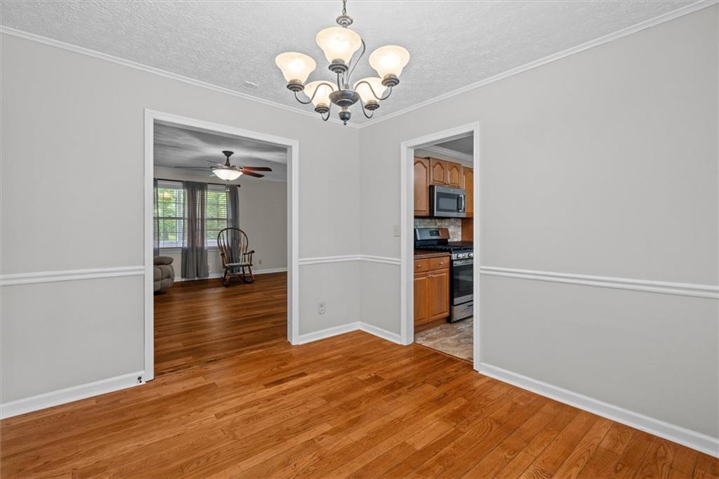 1267 Austin Bridge Road Douglasville, GA 30134 - Photo 16 of 66 a view of an empty room with wooden floor