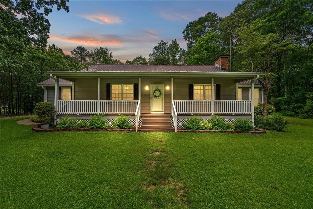 1267 Austin Bridge Road Douglasville, GA 30134 - Photo 2 of 66 a view of a house with a large windows and a yard