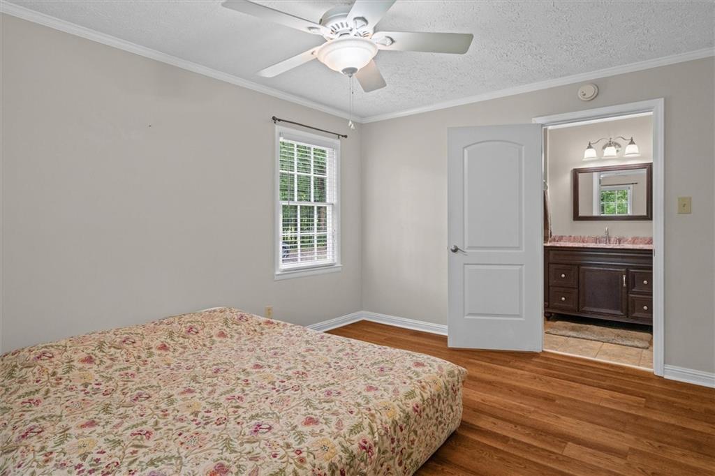 1267 Austin Bridge Road Douglasville, GA 30134 - Photo 23 of 66 a bedroom with a bed and a chandelier