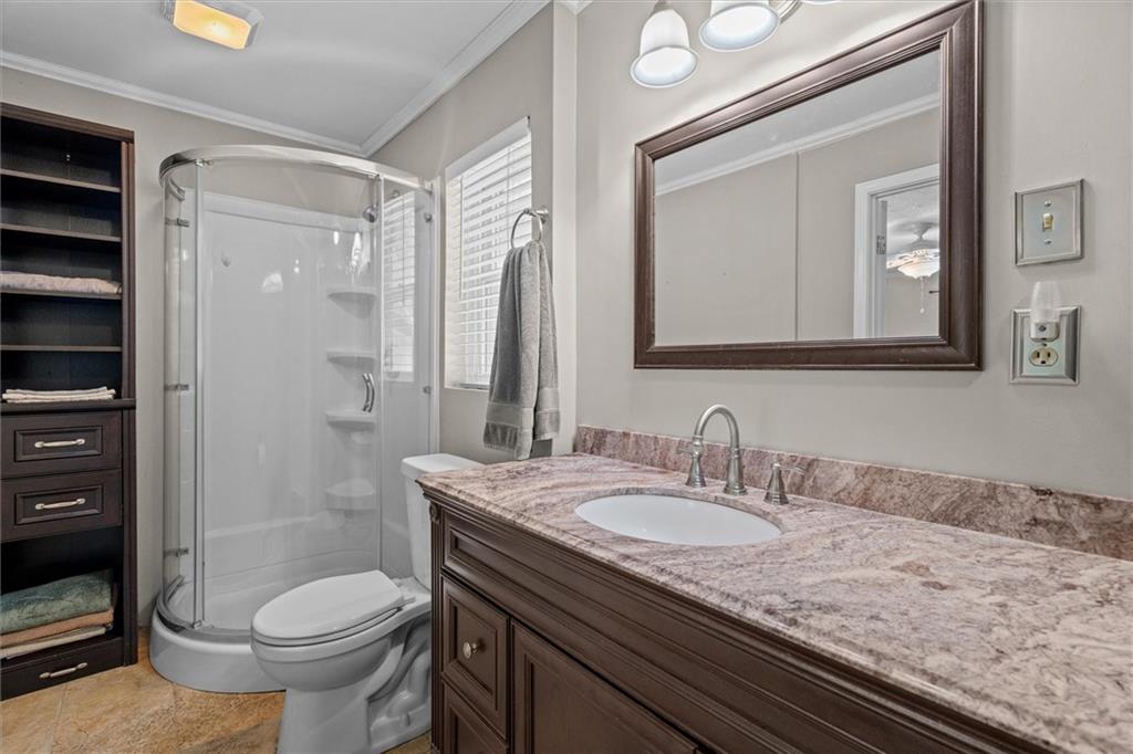 1267 Austin Bridge Road Douglasville, GA 30134 - Photo 24 of 66 a bathroom with a granite countertop sink toilet and shower