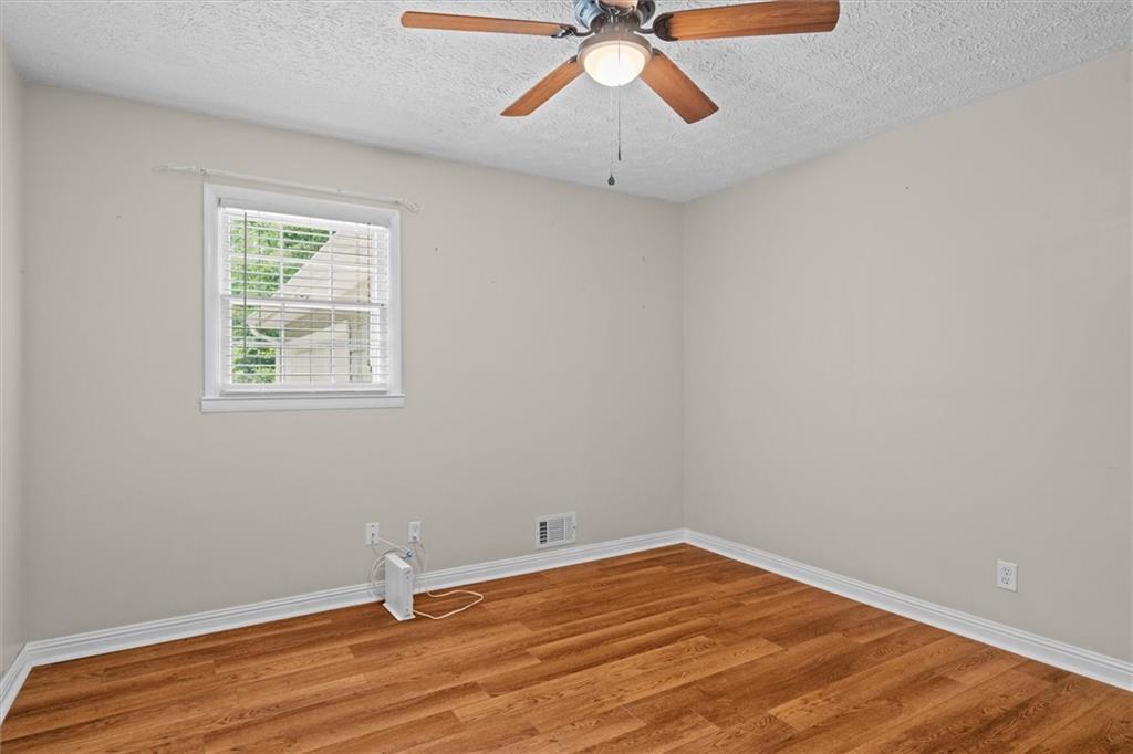 1267 Austin Bridge Road Douglasville, GA 30134 - Photo 27 of 66 a view of room with hardwood floor and ceiling fan