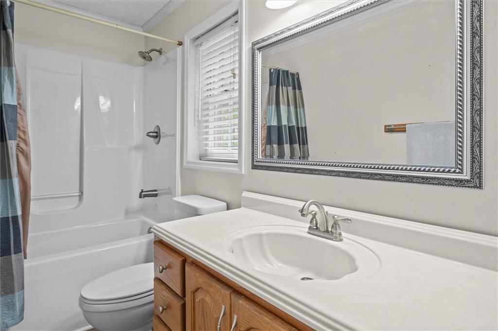 1267 Austin Bridge Road Douglasville, GA 30134 - Photo 28 of 66 a bathroom with a sink toilet vanity and shower