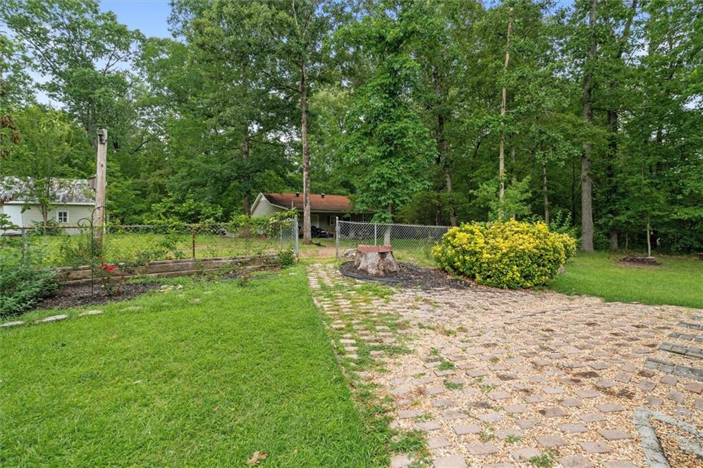1267 Austin Bridge Road Douglasville, GA 30134 - Photo 32 of 66 a view of a chair and table on the garden