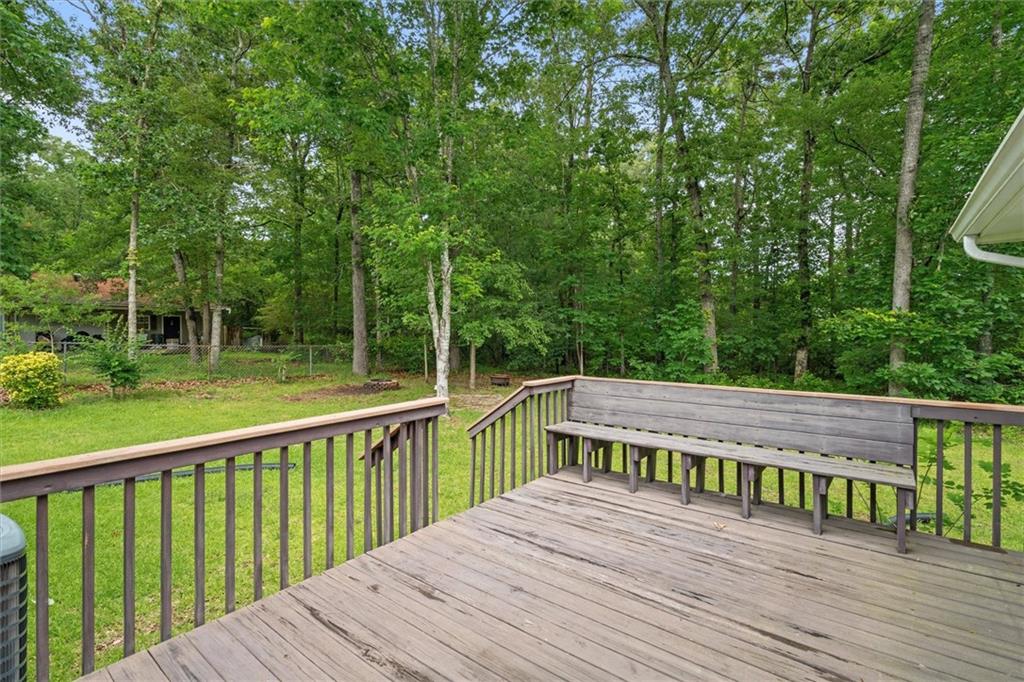 1267 Austin Bridge Road Douglasville, GA 30134 - Photo 33 of 66 a view of a wooden deck with a big yard