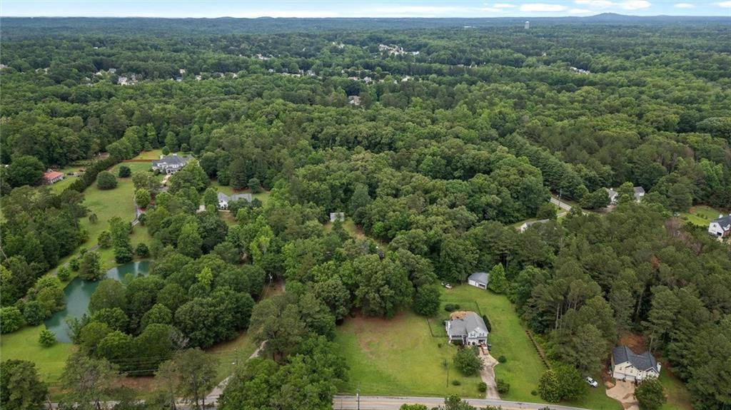 1267 Austin Bridge Road Douglasville, GA 30134 - Photo 39 of 66 an aerial view of residential houses with outdoor space and trees
