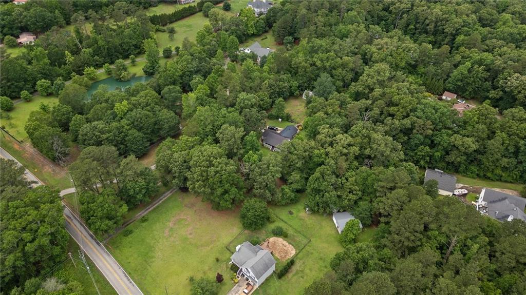 1267 Austin Bridge Road Douglasville, GA 30134 - Photo 40 of 66 an aerial view of residential house with outdoor space and trees around
