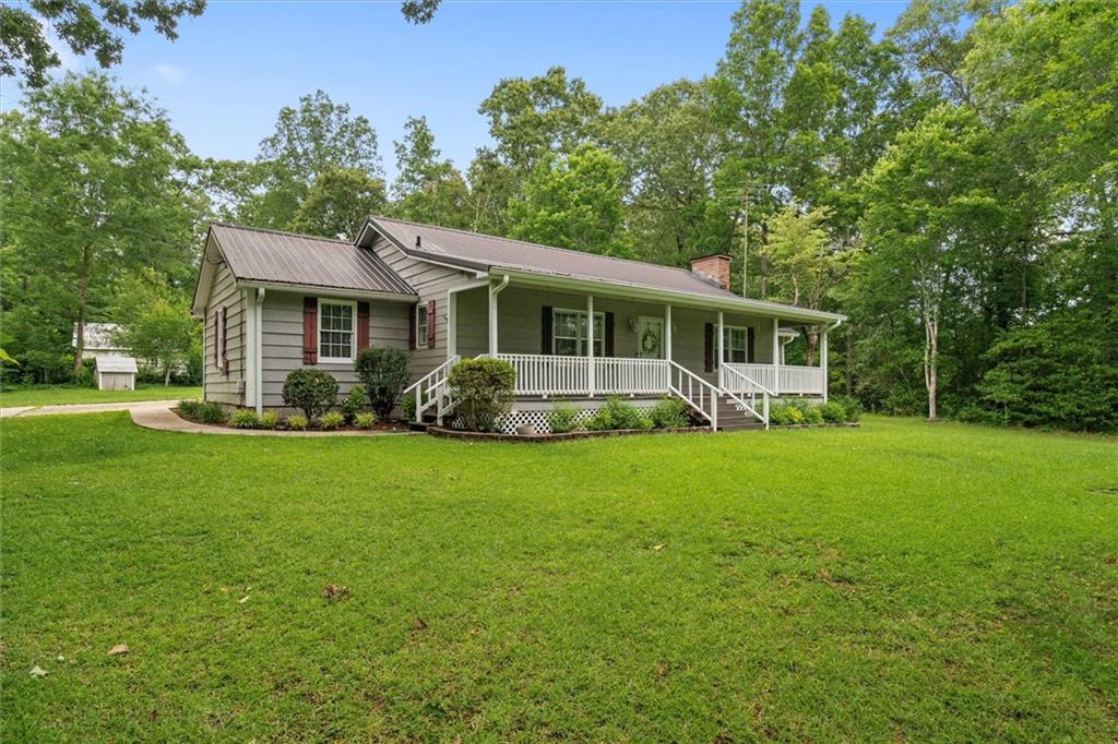 1267 Austin Bridge Road Douglasville, GA 30134 - Photo 4 of 66 a front view of house with yard and green space