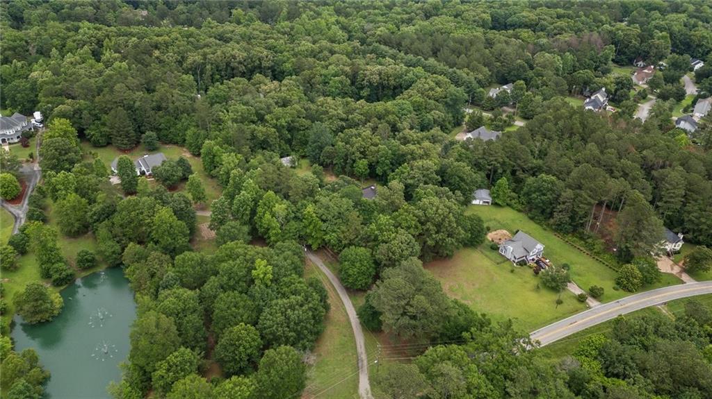 1267 Austin Bridge Road Douglasville, GA 30134 - Photo 41 of 66 an aerial view of residential house with outdoor space and trees all around