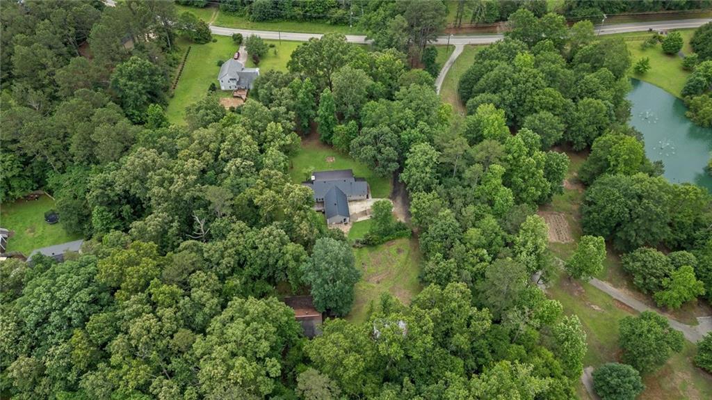 1267 Austin Bridge Road Douglasville, GA 30134 - Photo 44 of 66 an aerial view of residential house with outdoor space and trees all around
