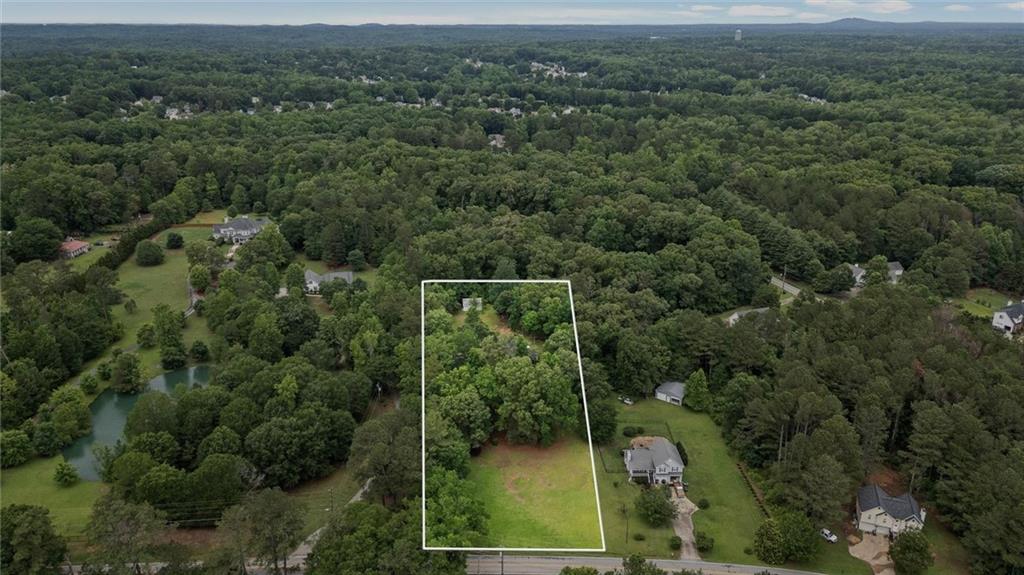1267 Austin Bridge Road Douglasville, GA 30134 - Photo 45 of 66 an aerial view of a residential houses with outdoor space and trees