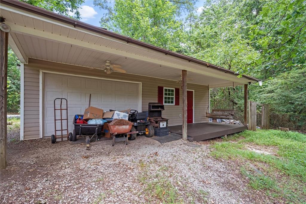 1267 Austin Bridge Road Douglasville, GA 30134 - Photo 49 of 66 a view of a patio with table and chairs couches and wooden fence