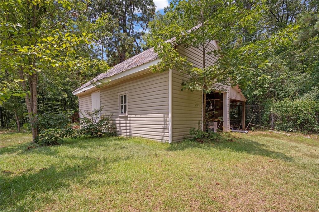 1267 Austin Bridge Road Douglasville, GA 30134 - Photo 59 of 66 a view of a house with a yard and garage