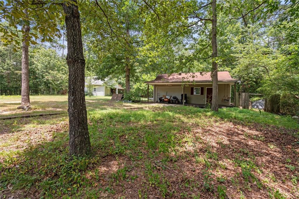1267 Austin Bridge Road Douglasville, GA 30134 - Photo 64 of 66 a front view of a house with a yard