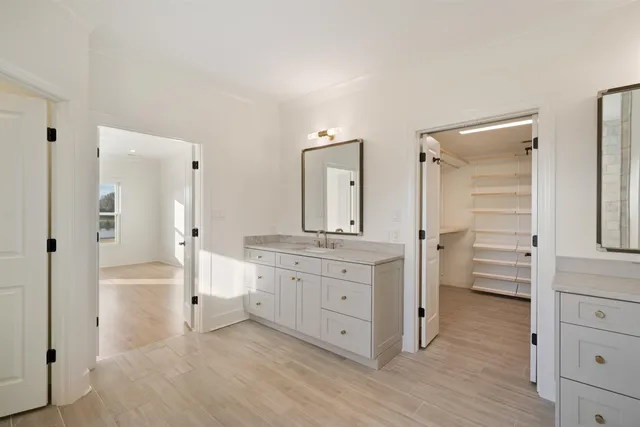 a bathroom with a sink a mirror and a shower