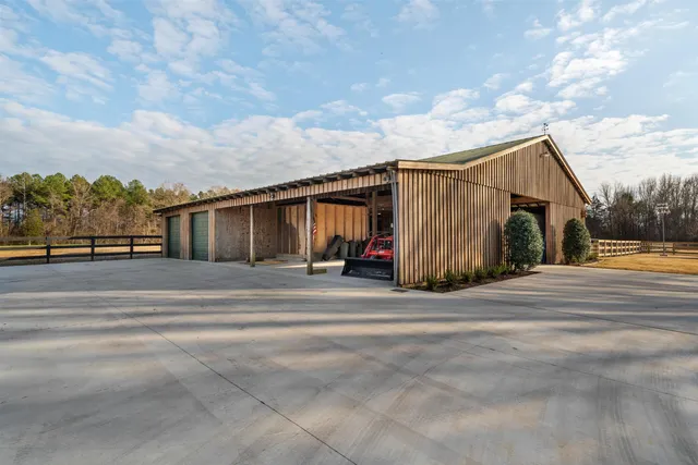 a bathroom with a granite countertop shower a mirror and a sink