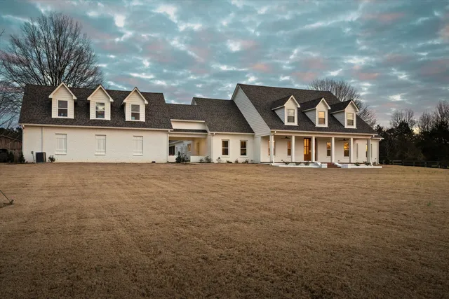 a front view of a house with outdoor seating