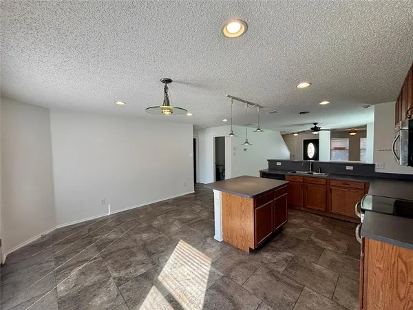 a kitchen with stainless steel appliances granite countertop a stove and a sink