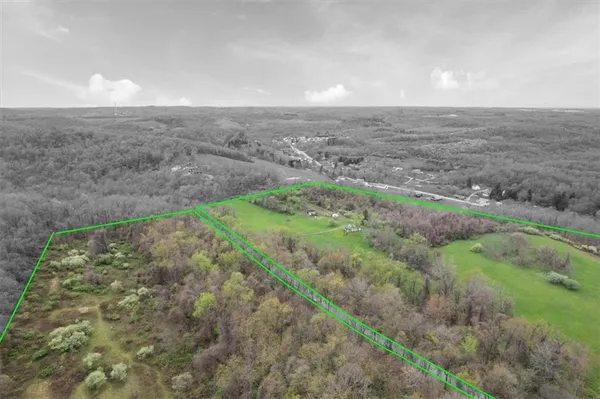 a view of a field with an ocean