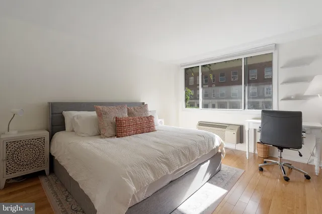 a bedroom with a bed tv and window