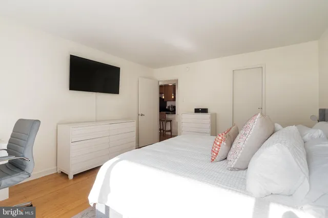 a bedroom with a bed and a flat screen tv