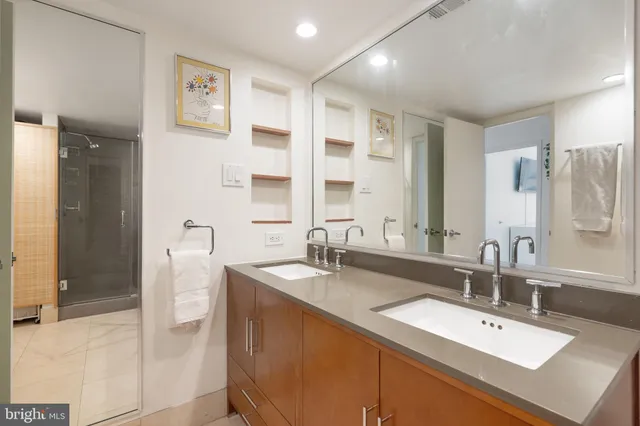 a bathroom with a sink double vanity and a mirror