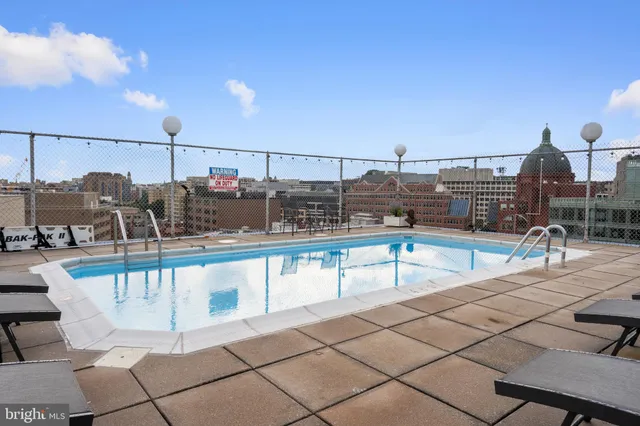 a view of a swimming pool with seating area