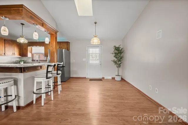 a view of a kitchen with furniture and wooden floor