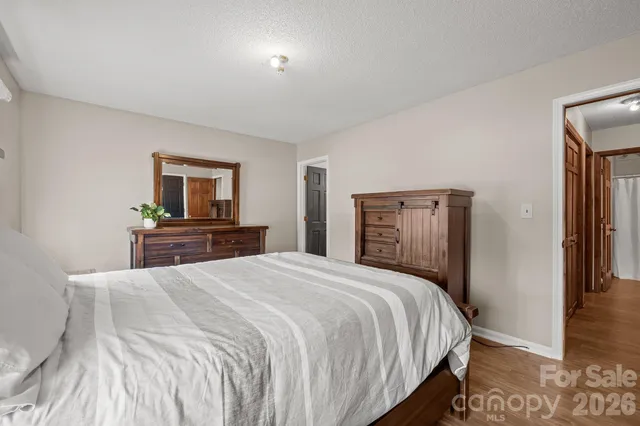 a bedroom with a bed and a tv on table