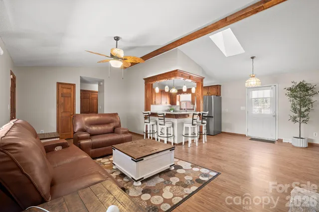a living room with furniture a window and a flat screen tv