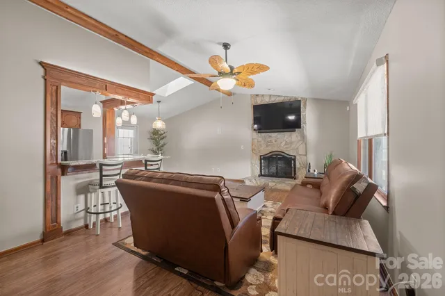 a living room with furniture a fireplace and a flat screen tv